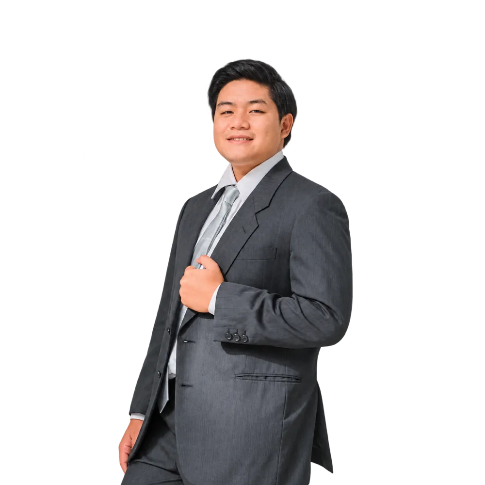 Portrait of Rian Ray De Asis, smiling in a grey suit